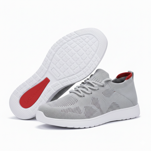 Gray sneakers with white soles and red accents on a white background